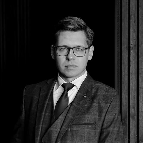 Mindaugas Dailidonis, black and white portrait in a tweed three-piece suit